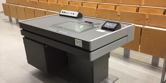 Desk with media equipment in lecture hall