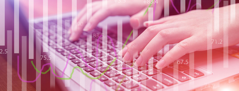 Diagrams and keyboard Female hands on keyboard behind transparent diagrams