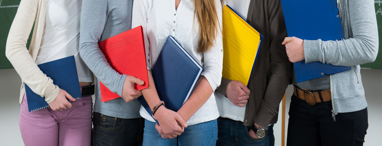 workbooks Five people with workbooks
