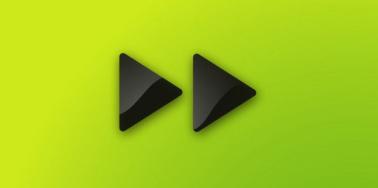 Zwei dunkelgraue nach rechts zeigende Dreiecke auf grünem Untergrund