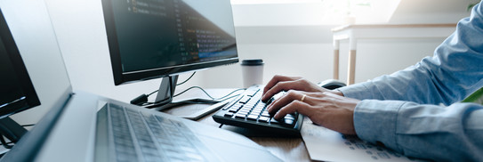 Programmer who checks software code on the screen