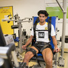 A man sits in an isokinetic meter.