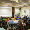 Audience in a hall listening to an event.