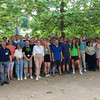 A large group consisting of students and teachers pose for a group photo.