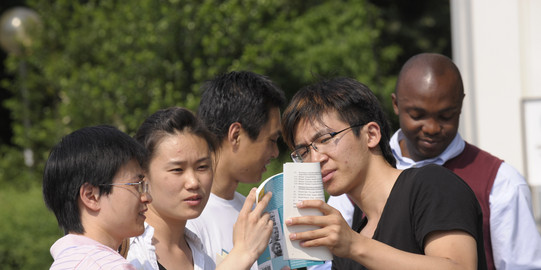 A group of international students talk to each other.